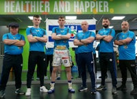 a group of men standing in front of a gym