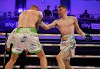 two boxers fighting in a boxing ring