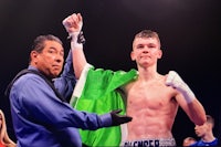 a boxer is celebrating after winning a boxing match