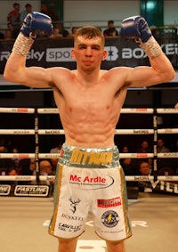 a boxer in a boxing ring with his fists raised