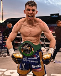 a boxer is standing on a boxing ring