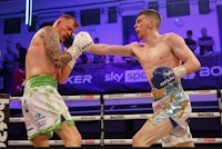 two boxers fighting in a boxing ring