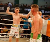 two boxers standing in a boxing ring