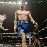 a boxer in a boxing ring with a referee