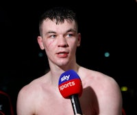 a young man with a microphone in front of him