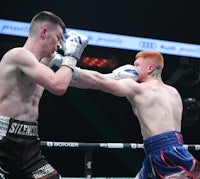 two boxers fighting in a boxing ring